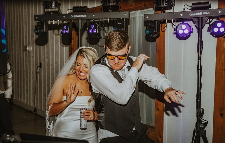 Bride and groom embracing at sunset at The Show Barn