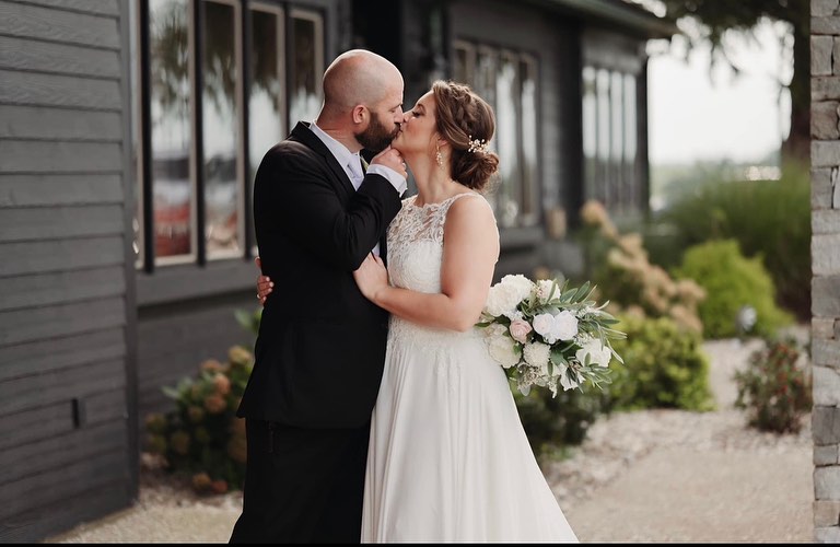 Couple kissing outside The Show Barn wedding venue